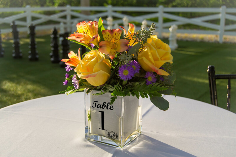 clear label on a glass vase filled with flowers