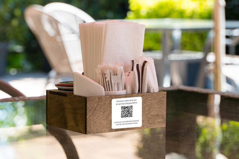 a cutlery box sits on a cafe table
