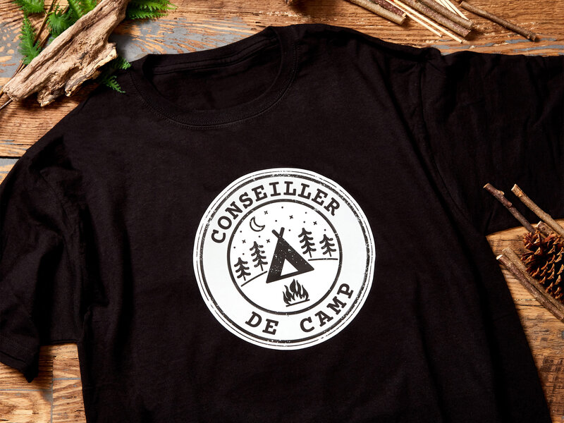 A black t-shirt with a white camp counselor logo on it